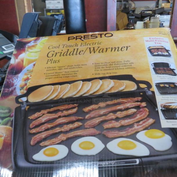 Presto Cool Touch Electric Griddle Warmer Plus in box, features non-stick surface, slide-out drip tray, ideal for pancakes, bacon.