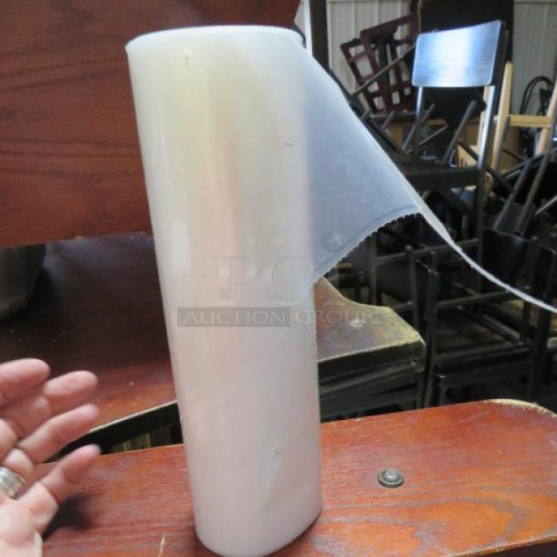 A roll of clear pastry bags, shown standing upright. Appears new, with attached perforated edge for easy dispensing.