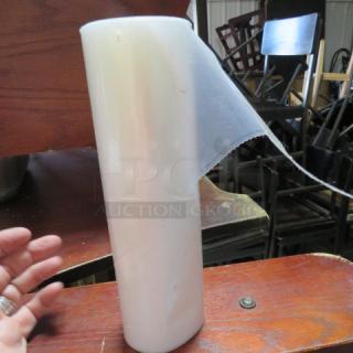 A roll of clear pastry bags, shown standing upright. Appears new, with attached perforated edge for easy dispensing.