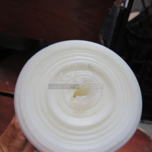 One roll of pastry bags, tightly wound, showing smooth plastic layers, ideal for baking and decorating tasks.