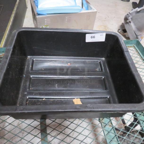Black plastic bussing tub with ribbed interior; moderate wear. Label marked "66" indicates item number.