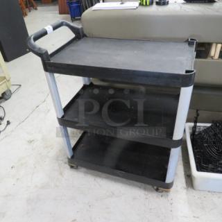 Black 3-shelf utility cart on casters, 31x17x36 inches, durable plastic with metal supports, in good condition.