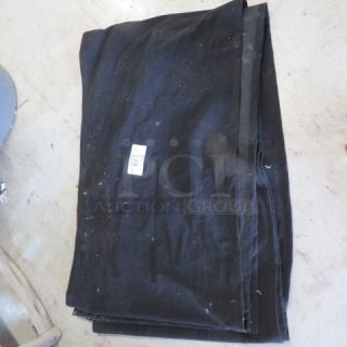 Black velvet stage cover with Velcro, dimensions 320x18, folded and slightly worn, white label with text.