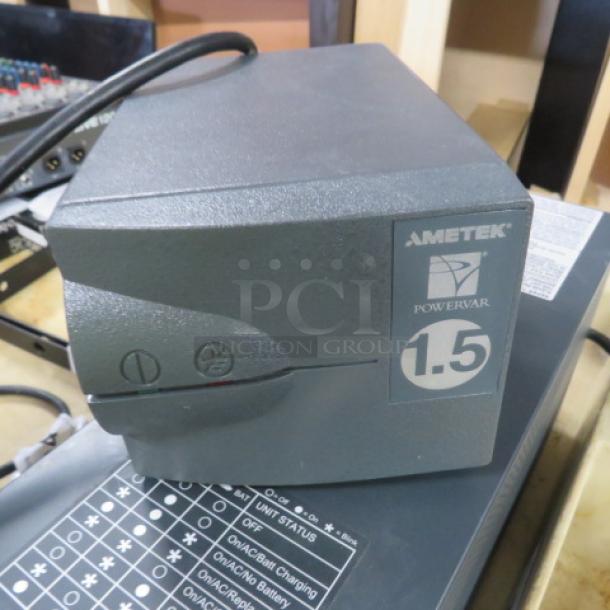 Ametek Powervar 1.5 Battery Backup, model #ABC150-11, gray, showing front power button and status labels. Good condition.