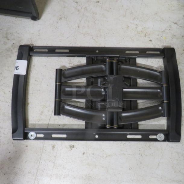 Adjustable black TV wall mount, metal construction, pristine condition, includes mounting brackets and screws.
