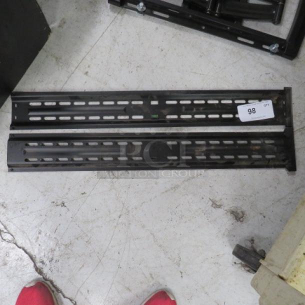 Black metal bracket, model 2XBID, with slot design. Slight wear, tag labeled "98". Suitable for industrial use.