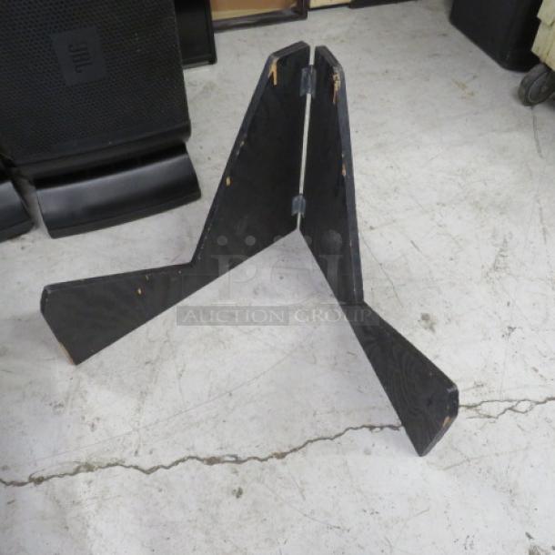 Black wooden holder, foldable design, with visible wear on edges. Ideal for displaying items, sturdy construction.