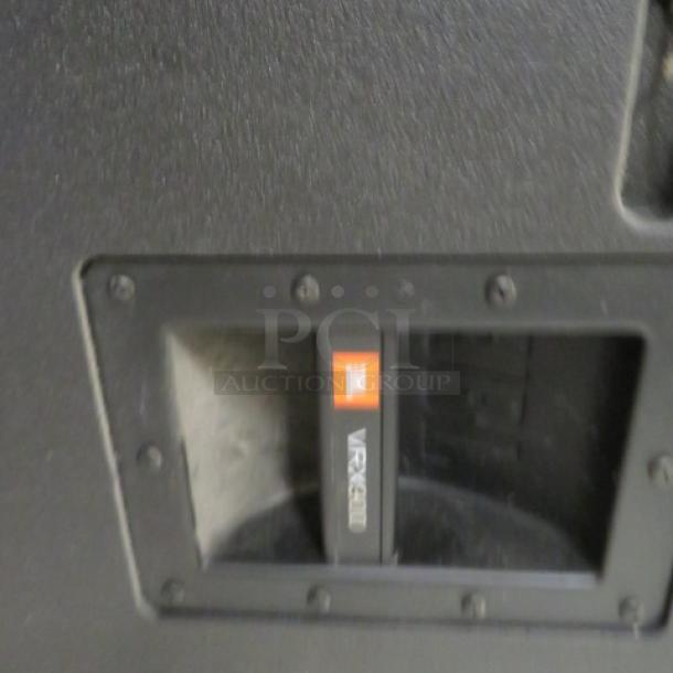 JBL VRX900 speaker, black, close-up of model label, pristine condition, robust build, ideal for professional audio use.