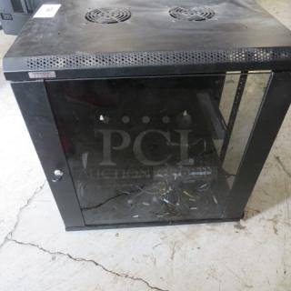 One Omni Mount equipment wall mount box, black, with glass front door. Missing one side panel, visible wear.