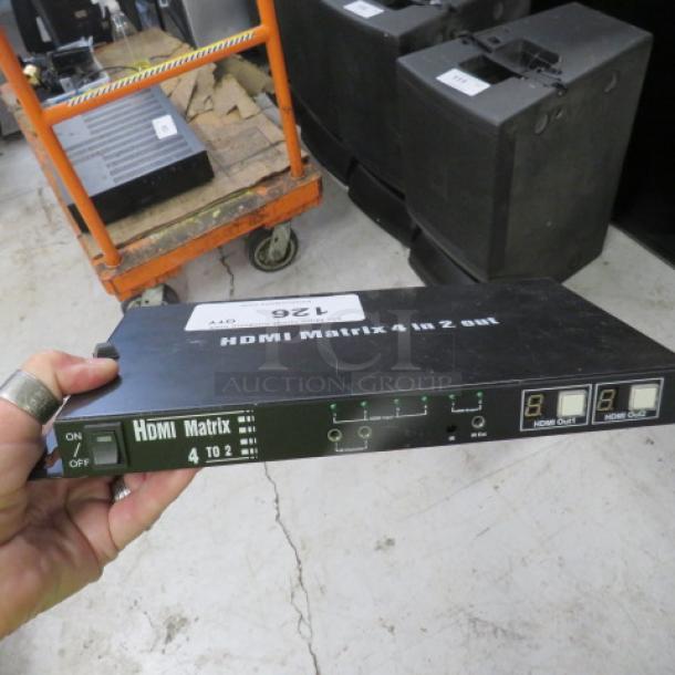 HDMI Matrix 4 In 2 Out switch, black, with power button and indicator lights. Used condition with visible label.