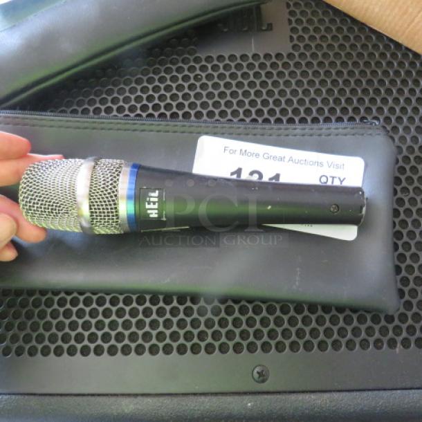 Heil microphone with silver grille, black body, logo visible, placed on black zipper bag. Excellent condition.