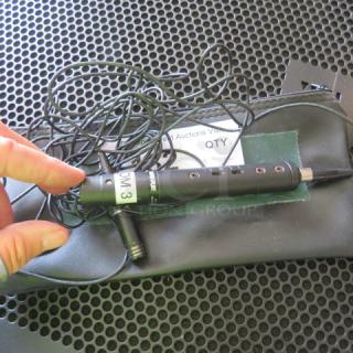 Shure microphone without cover, in zipper bag. Features visible wires and label reading "3 M." Appears gently used.