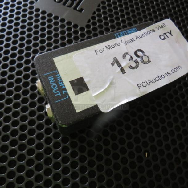 Compact audio splitter with two input/output jacks, label "High In/Out," auction tag number 138, black metal casing.