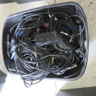 Large bundle of stage and power cords in a storage bin; various lengths and connector types, mixed condition.