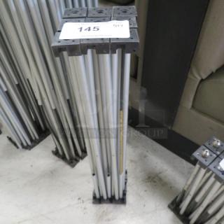Foldable stage base with metal frame, lot number 145 label visible. Compact design for easy storage and transport.