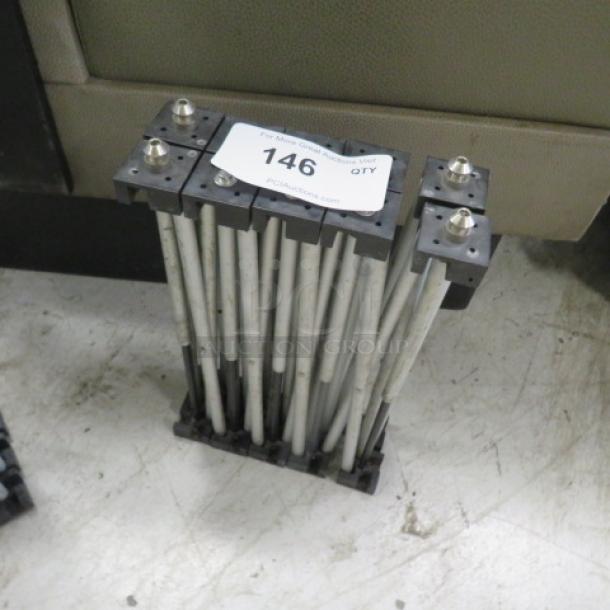 Foldable stage base with metal rods and connectors, marked with tag "146." Compact design, suitable for portable stage setups.