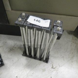 Foldable stage base with metal rods and connectors, marked with tag "146." Compact design, suitable for portable stage setups.