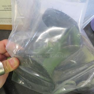 Foot Levelers 3XBID in plastic bag, green color, slight wear visible. Used condition, held by hand, with boxed background.