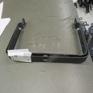 Black metal bracket with mounting holes, in good condition. Includes attached label. Suitable for structural support.
