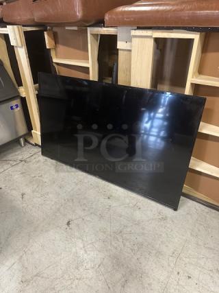 LG 65" flatscreen TV, model 65LB5200UA. Used, resting on floor. No visible damage.