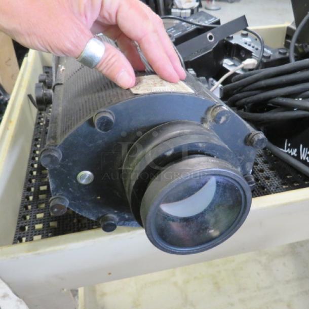 Stage Light #LEDB90E, black, cylindrical design, used condition; features lens, mounting hardware, and power cords visible.