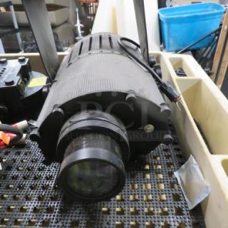 Black stage light with lens, vented housing, and attached power cables. Working condition; suitable for theater use.