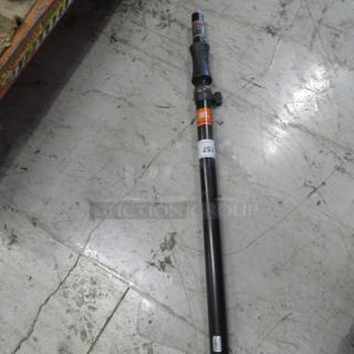 JBL Professional Telescoping Speaker Pole, model JBLPOLE-GA, shown on a concrete floor. Features automatic raising.