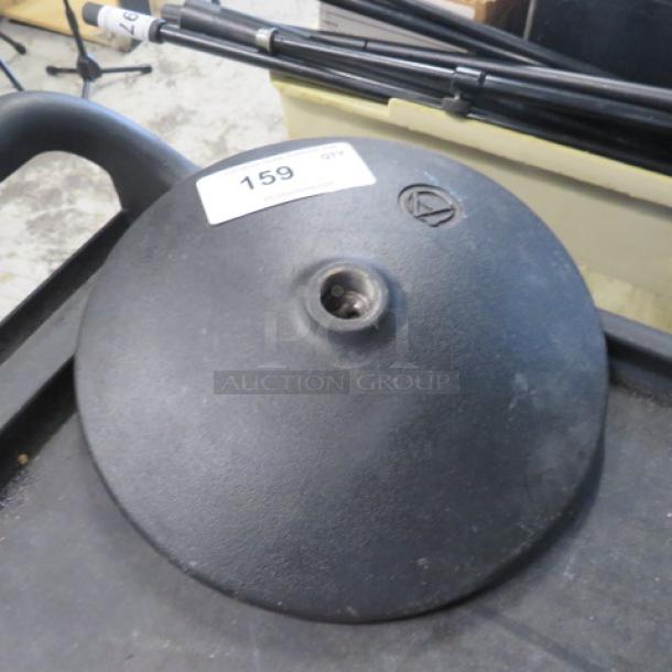 Black microphone base, circular, with an Audio-Technica logo and a central mounting hole. Label marked "159".