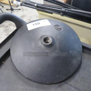 Black microphone base, circular, with an Audio-Technica logo and a central mounting hole. Label marked "159".