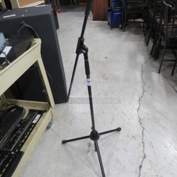 Adjustable mic stand with tripod base in good condition, featuring a height-adjustment knob and a visible "16" label.
