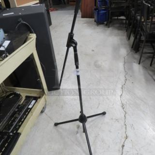 Adjustable mic stand with tripod base in good condition, featuring a height-adjustment knob and a visible "16" label.