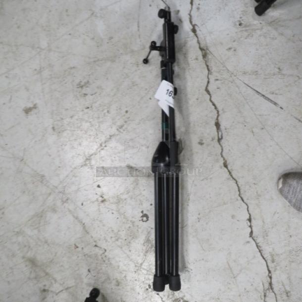AKG mic stand, black, collapsible, sturdy base, adjustable height. Tag visible with number "16". Good condition.