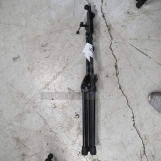 AKG mic stand, black, collapsible, sturdy base, adjustable height. Tag visible with number "16". Good condition.