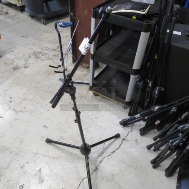 AKG microphone stand with adjustable height and boom arm in good condition, tag labeled "15" attached.