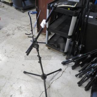 AKG microphone stand with adjustable height and boom arm in good condition, tag labeled "15" attached.