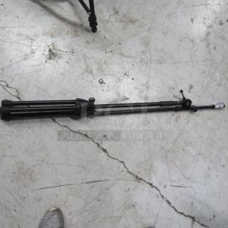 Black telescopic microphone stand with tripod base on a concrete floor. Adjustable height, good condition.