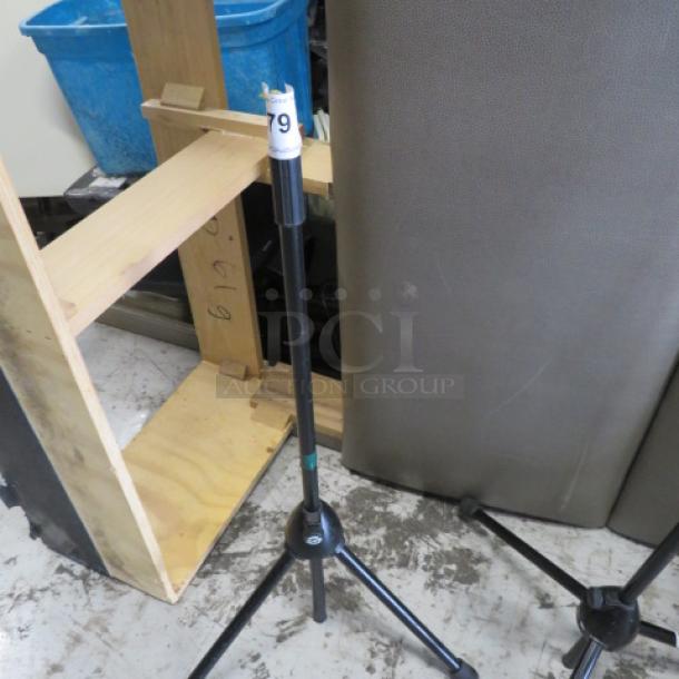 K & M stand, black, adjustable height, sturdy base. Good condition, visible label with number 79, ideal for equipment support.