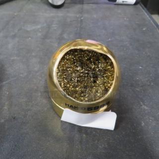 Gold Hako Tip Cleaner #599B with metal filings, used for soldering tip maintenance. In good condition. Marked "Hakko 599B".