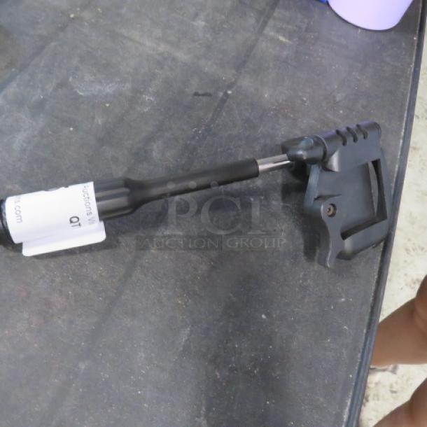 Targus holder on table, black with adjustable features, label attached. Good condition, suitable for mobile device support.