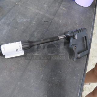 Targus holder on table, black with adjustable features, label attached. Good condition, suitable for mobile device support.