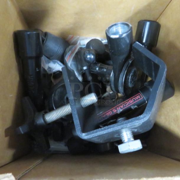 Box of assorted hardware components, including clamps and screws. Some items marked "MUSICIAN'S GEAR." Mixed condition.