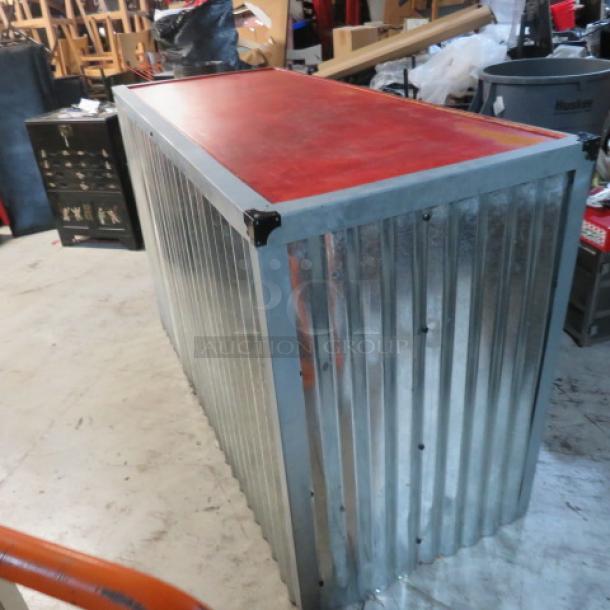Wooden metal hostess stand with red top. Features three under shelves, corrugated metal sides. Size: 67x28x41.