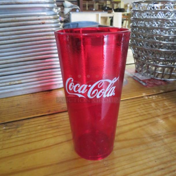 Red 24oz Coca-Cola tumbler, new condition, featuring Coca-Cola logo. Case includes 24 tumblers.