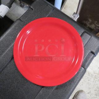 Red 9-inch Carlisle melamine plate, model N43501, showing light surface wear. Durable and ideal for heavy use.