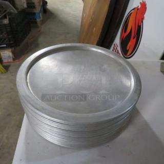 10-inch aluminum pizza pan stack, durable and lightly used, ideal for restaurants or home use.