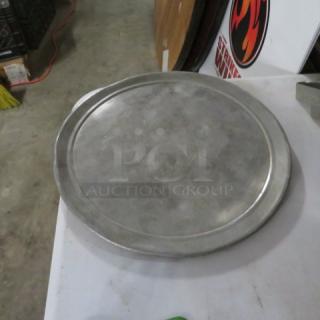 12-inch metal pizza pan, used condition. Smooth surface, slight wear visible. Ideal for baking and serving pizzas.