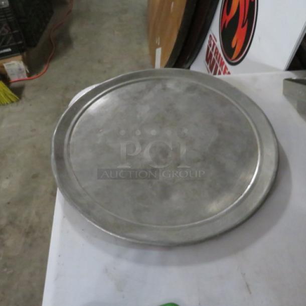 12-inch metal pizza pan, lightly used, smooth surface, slight edge wear, ideal for baking or serving.