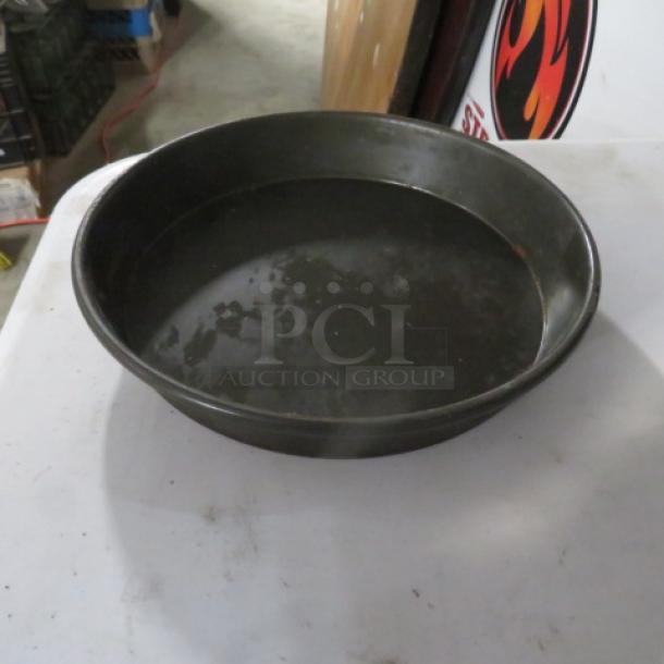 8-inch deep dish pizza pan in used condition, metal with slight wear. Marked "10XBID" indicating model or lot number.