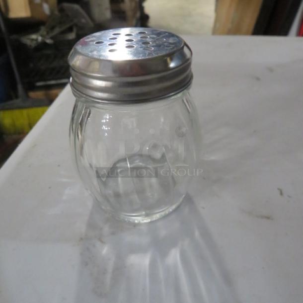 Glass cheese/pepper shaker with metal lid, item 12XBID, in good condition. Ribbed design for easy grip.
