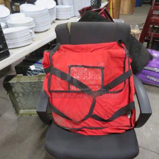 Red One Choice pizza delivery bag with black straps, viewed on a chair. Visible clear vinyl pocket on the front. Used condition.